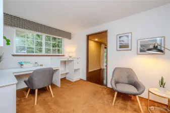 The Home Office offers a number of built-ins with options for sitting or standing at your desk. A coat closet is to the left (not pictured). A pretty glass paned French door on the right opens to the Family Room.