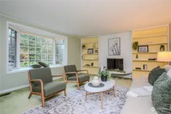 The spacious Living Room is warm and inviting with a pretty multi-paned bay window, a cozy wood burning fireplace with white brick floor to ceiling surround and built-in shelves and crown molding.