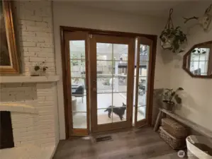 Unlike a traditional sliding glass door, this back door features a full-sized center door flanked by two side panels that can be opened independently, allowing for partial ventilation or a wide-open feel.