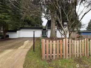 The front yard is fully enclosed with a charming picket fence, adding to the home's quaint and inviting appeal.