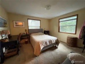 Bedroom #2 is shown with a full-size bed and still offers plenty of extra space. It features not one but two windows, bringing in an abundance of natural light.