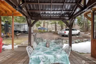 Under the gazebo, the dining cabin is to the left. The RV parking is ahead. And the primary suite cabin is to the right.