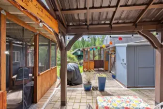 Ahead you can see the bathouse cabin. To our right there is a covered porch before entering the primary suite cabin.