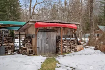 Wood stack and woodshed. It's fun to take the canoes to the priavte lake in the community.