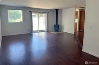 Spacious living room with sliding doors leading onto the deck and a wood burning fireplace