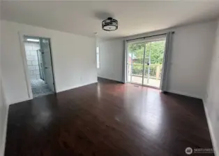 Spacious Master bedroom with en suite bathroom, walk in closet and sliding door leading to the deck
