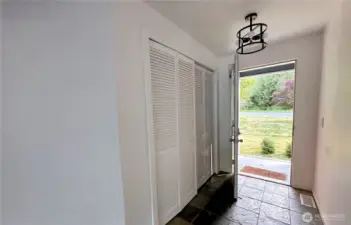Hallway to front door with hallway closet on entry