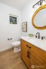 Main floor powder room is sensible in size.