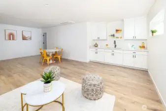 Looking towards the wet bar, kitchen area and extra space in the background. Designed to accommodate a pool table!  Just past there, is more bonus storage space!