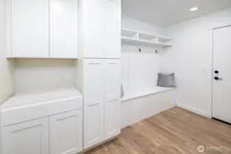 So many extras and bonus spaces for storage in this home.  This is the entry from the garage entrance into a generous mud room, bench, closet system and storage cabinets. It's a fabulous upgrade to the standard builder design!  (countertop has been installed).