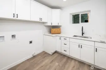 A standout utility room with thoughtful cabinetry, abundant space, and a stylish setting to make laundry feel effortless.