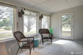 Front door in the sunroom. Low mainenance tile floors.