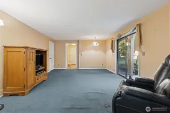 Main floor family room with sliding door to outside. Utility room straight ahead.