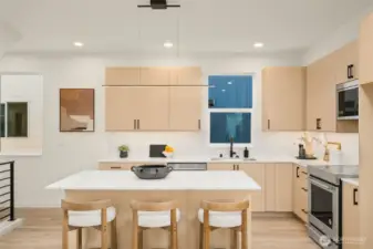 Just off the kitchen, the dining area offers a dedicated space for meals under modern pendant lighting.