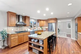 Spacious chef's kitchen with central island, stainless appliance suite, double ovens