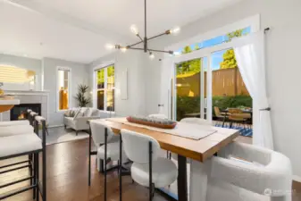 Host with ease in this open-concept living and dining area, where natural light pours in from large windows and doors that lead to the backyard.