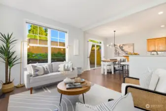 Host with ease in this open-concept living and dining area, where natural light pours in from large windows and doors that lead to the backyard.