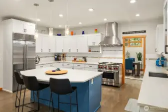 A beautiful, functional and inviting Chef's kitchen with gas Wolf range, Meile dishwasher, SubZero refrigerator and pantry.