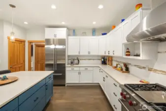 Oversized Quartz seating Island, and subway tile backsplash.