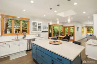 Adjacent is a large eating nook and planning desk, with great sightlines to the family room and outdoor space.