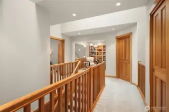 Enter the upper-level to newer carpeting and a sunlit loft/library with built-in bookcases which could serve as a second office space.