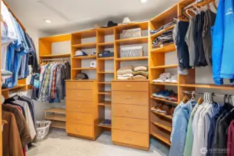 The large primary bedroom walk-in closet features California Closet built-ins.