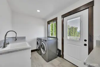 laundry room with cabinets and sink