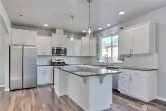 Spacious kitchen with granite countertops and stainless steel appliances