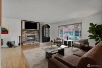 Gas Fireplace and large windows overlooking the front garden area.