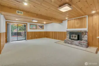 Lower Level Family/Bonus room feautres wood fireplace and access to the backyard