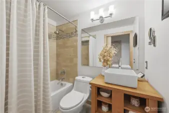 Awesome tile full bath with cool wood vanity.