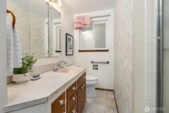 full bath with generous vanity storage and a clean, functional layout.