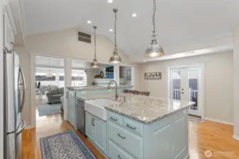 View of kitchen looking over living room, dining area and views of the water.