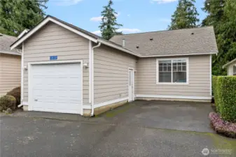Attached one car garage with additional parking space.
