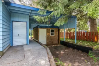 Separate storage room with roll-up door, large carport. Keep the shed for secured storage or remove for tons of covered parking.