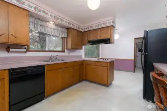Kitchen has tons of cabinets and opens to breakfast nook with large window to the back yard.