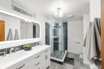 This private ensuite bath is freshly renovated. Gorgeous tile, dual vanity and glass shower.