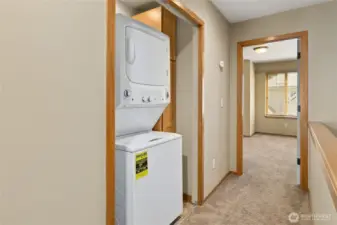 Washer & Dryer centrally located between both bedrooms on upper level.