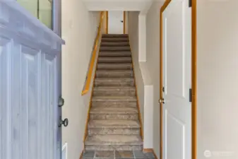 Granite entry with garage door off to the right and stairs to the main living area.