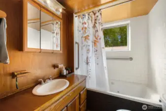 The main floor full bath is down the hall from the bedroom. They did not do "primary suites" in 1901.