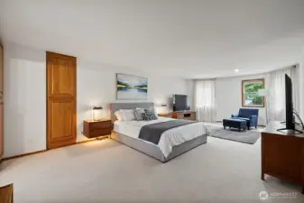 Virtually staged primary bedroom has two huge walk in closets