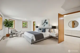 This virtually staged primary bedroom takes up the whole side of the house