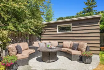 Outdoor fireplace with large storage shed behind