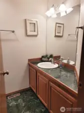 Main floor half bathroom with marble tile