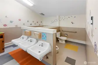Behind the handwashing station.