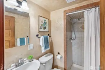 bathroom with shower tiled