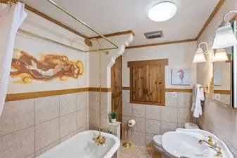 full bathroom with a Claw footed tub and built in cabinets