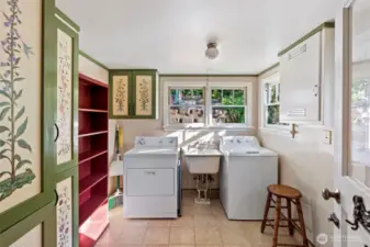 laundry room off of the kitchen built in hand painted cabinets