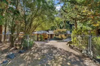 Welcome Home! Which is located in a private & secluded location. Starting with a gate that opens to your future personal retreat. With established flowers, trees & greenery to enjoy all year round. This home was meant for a car enthusiast, a hobbiest or whatever your heart desires!