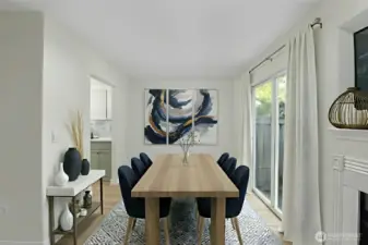 Dining area positioned between the kitchen and living room for an efficient, open-concept layout. Virtually Staged